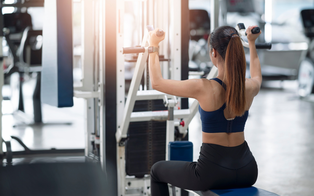 Rear View of  Young Fitness Woman Execute Exercise with Exercise